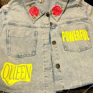 Ladies cropped jean jacket with neon lettering and designs.
